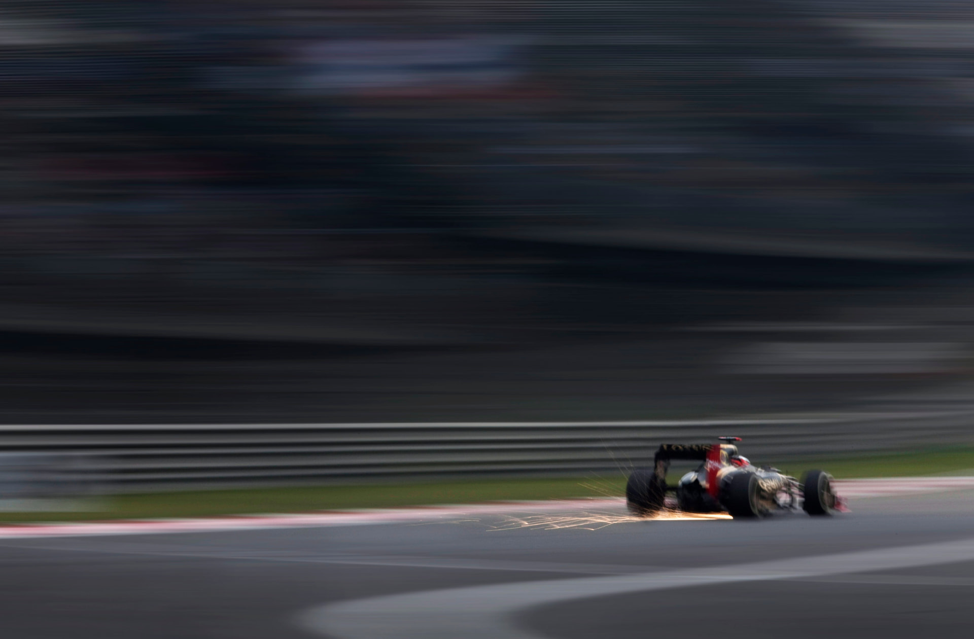 Lotus F1 car trailing sparks at speed, China 2012