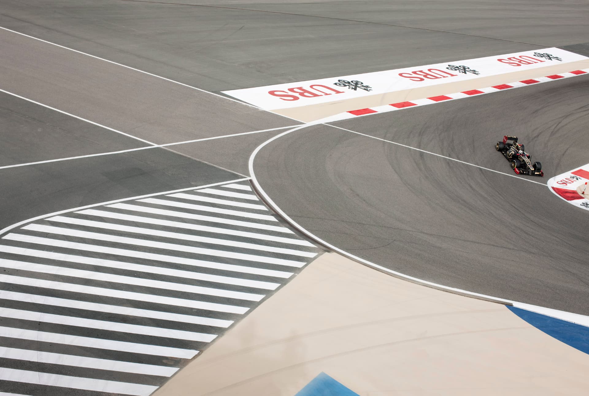 Overhead view of a Lotus F1 car through a Bahrain corner